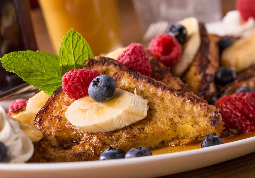 plate of french toast with fruit