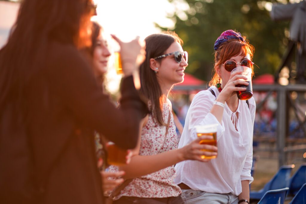 women drinking beer at an outdoor festival