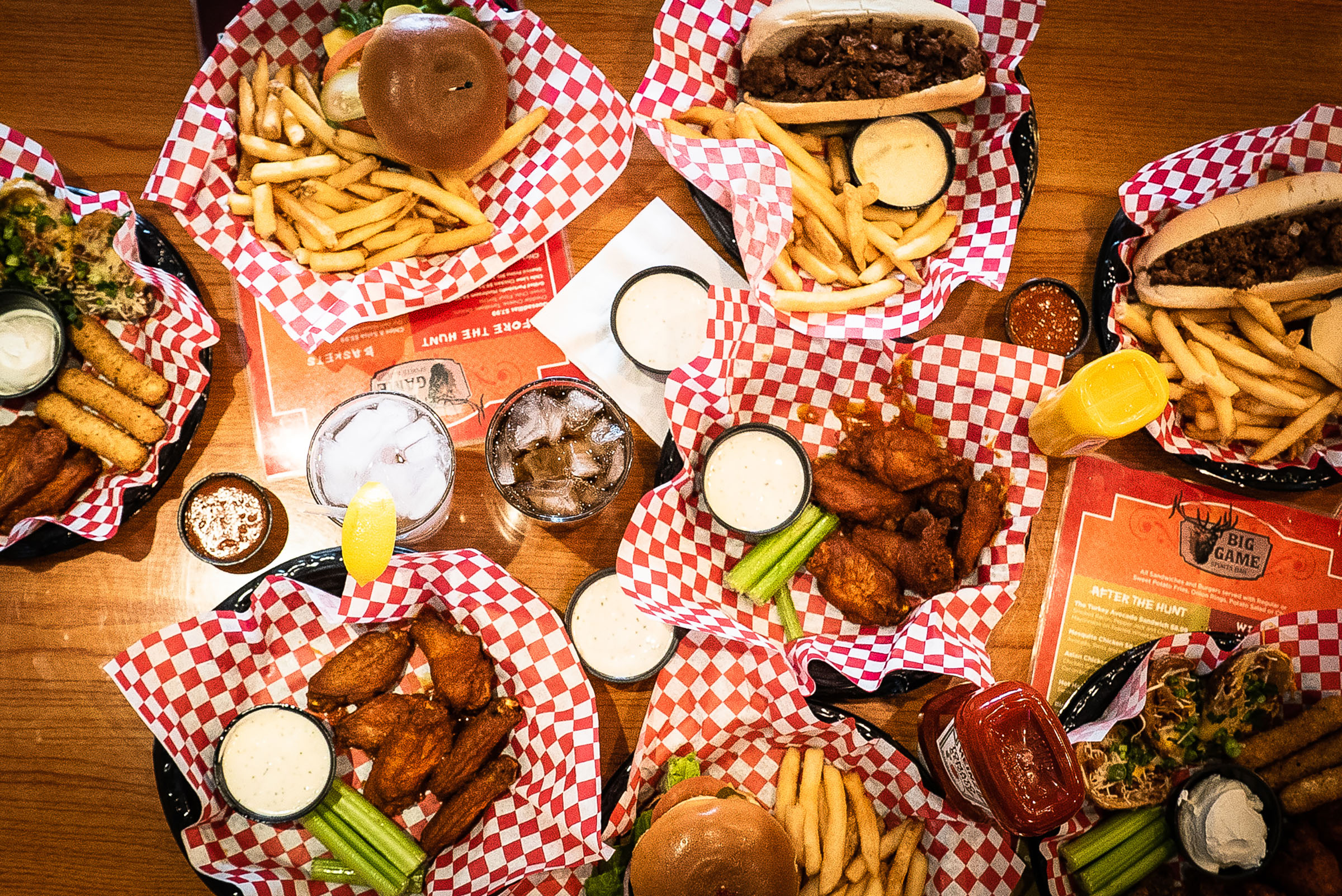 Baskets of chicken wings, burgers, and bar food.