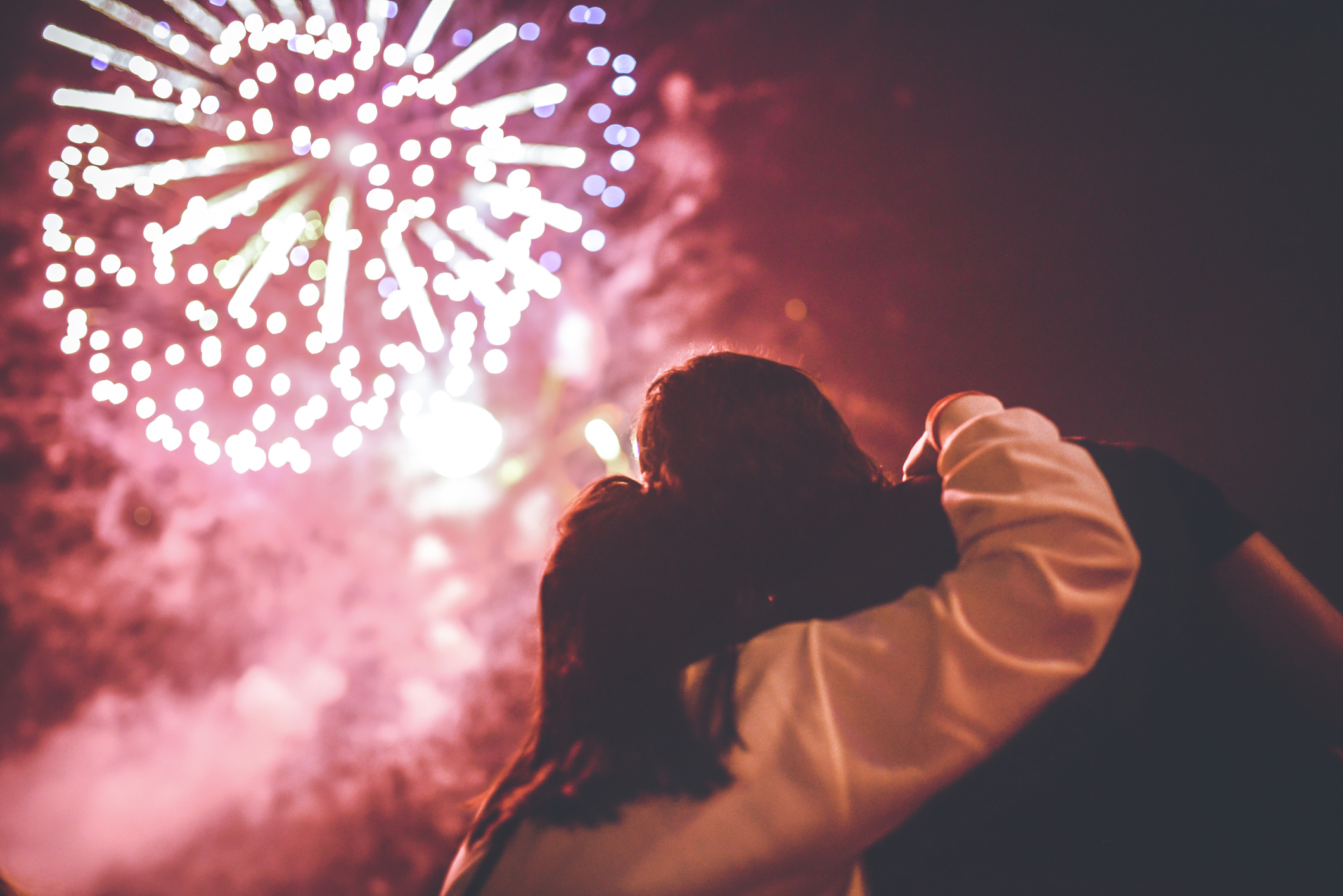 A romantic couple watching fireworks.