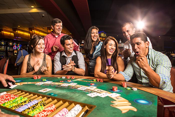 Guests playing table games at Inn of the Mountain Gods Casino.